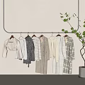 Minimalist Neutral Tones Clothes Hanging On Arched Frame With Green Plant