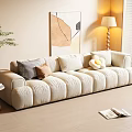 Plush Beige Three Seater Sofa With Decorative Pillows Side Table And Lamp