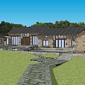 Rustic Stone House Exterior With Slate Roof And Stone Path Through Green Grassland