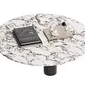 Stylish Round Coffee Table With Marble Texture Top Black Base Notebook And Gray Device On Surface 3d model