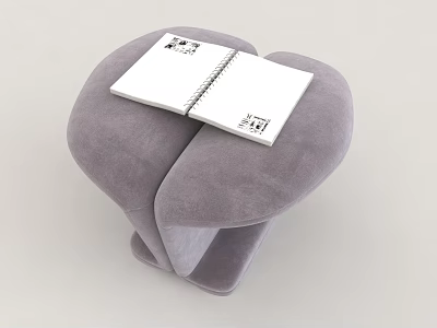 Gray Padded Stool with Unique Curved Design and Open Notebook on Top 3d model