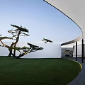 Serene Garden Landscape With Green Lawn Pine Trees White Buildings And Open Sky