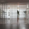 Transparent Glass Block Wall in Modern Interior Space with Partition and Green Plants
