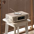 Wooden Stereo Speaker With Mobile Phone On Top And Digital Display On White Table