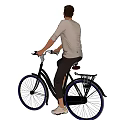 Man riding black bicycle with rear rack wearing gray shirt dark pants and white shoes
