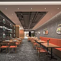 Modern Restaurant With Orange Booths Wooden Tables Black Walls Circular Decorations And Ceiling Lights