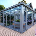 Glass Greenhouse Style Restaurant With Transparent Roof Dining Area And Indoor Plants
