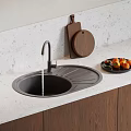 Modern Kitchen Sink with Faucet on White Countertop and Wooden Cutting Board and Fruit Plate