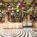 Vibrant Café Interior With Colorful Circular Ceiling Decor Wooden Bar Brunch Menu And Spiral Floor