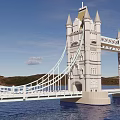 Iconic Scenic Landscape Bridge Featuring Tall Towers Spires Spanning Calm Water Blue Sky And Hills