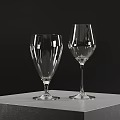 Two Elegant Transparent Wine Glasses Placed On Grey Table Against Dark Background