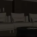 Cream Colored Three Seater Sofa With Cushions And Black Round Coffee Table Wooden Wall Background