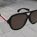 Stylish Black Sunglasses With Red Stripe Frame On Gray Floor Tile Design