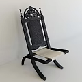 Black Wooden Leisure Chair With Intricate Carved Design And Light Colored Cushion
