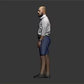 Man Standing with Hands in Pockets Wearing White Shirt and Blue Shorts Against Gray Background