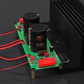 Green Electronic Circuit Board With Capacitors Heat Sink And Red Wires