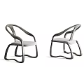 Two Modern Leisure Chairs With Curved Armrests And Gray Padded Seats