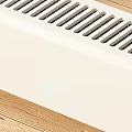 White Baseboard Electric Heater in Room Corner on Wooden Floor with Sunlight and White Curtains