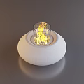 Stylish White Round Coffee Table With Glass Bowl Featuring Flames and Decorative Stones