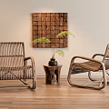 Two Rattan Leisure Chairs With Small Wooden Table Potted Fern And Decorative Wall Art On Wooden Floor