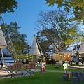 Serene Garden Landscape with Conical Tents Tall Trees String Lights and Outdoor Activity Spaces