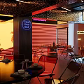 Vibrant Restaurant Interior With Neon Signs Tropical Plant Patterns Red Yellow Tones And Modern Seating