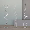 Three Modern Spiral Design Floor Lamps with Chrome Base and Curved Structure in Minimalist Room