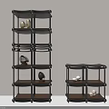 Black Multi Tiered Storage Shelves With Decorative Stones And Minimalist Design