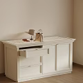 White Cabinet With Handbag Eyeglasses And Table Lamp In Light Room With Wooden Floor