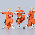 Three men wearing orange robes performing traditional martial arts with dynamic poses