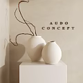 White Decorative Vases with Brown Branches on White Pedestal against Beige Wall with AUDO CONCEPT