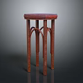 Red Wooden Stool With Round Textured Seat And Curved Legs Design