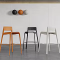 Modern Colorful Bar Stools In Interior Setting With Wall Mounted Decorative Spheres