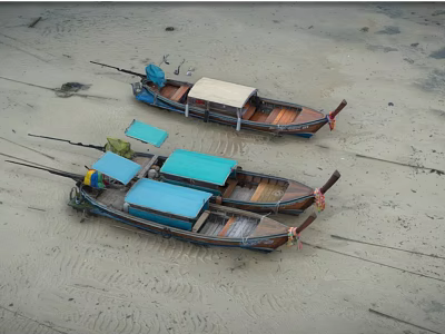Two Wooden Fishing Boats With Blue Canopies Parked On Sandy Beach 3d model