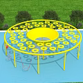 Yellow Circular Playground Equipment With Multiple Hoop Platforms On Blue Surface And Green Grass