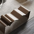 Brown Leather Bench with Unique Wave Shaped Design on Carpeted Floor and Wooden Surface