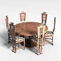 Elegant Carved Dining Chairs Surrounding Round Wooden Table With Metal Accents