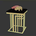 Small Table With Black Tabletop And Golden Metal Frame Featuring Two Pink Pig Shaped Ornaments