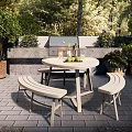Outdoor Patio Table and Bench Set with Green Plants and Grill in Garden