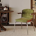 Green Velvet Accent Chair With Metal Frame In Modern Interior With Wooden Table And Plant