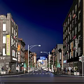 Vibrant Night View Commercial Street With Buildings On Both Sides Shop Signs Pedestrians And Vehicles