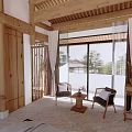 Hotel Guest Room With Wooden Beams Natural Light Seating Area And Floor To Ceiling Windows