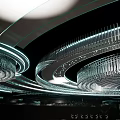 Elegant Modern Banquet Hall With Circular Ceiling Crystal Chandelier Light Strips Mirrored Floor And Tables