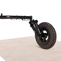 Black Tire With Rim Connected To Spring Support Mechanism On Gray Surface