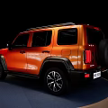 Orange SUV with Black Rims and Roof Rack on Display Stand Against Black Background