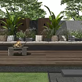 Stylish Outdoor Sofa With Cushions And Fire Pit On Wooden Deck With Green Plants