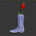 Blue Cowboy Boots with Star and Pattern Decorations Used as Flower Vase Holding Red Tulip