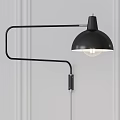Black Wall Lamp with Curved Metal Arm and Hemispherical Shade Mounted On White Wall Lit