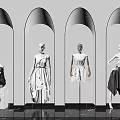 Four Fashion Mannequins Wearing Different Outfits in Arched Background