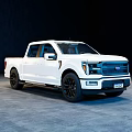 White Modern Pickup Truck With Crew Cab And Black Wheels In Indoor Setting